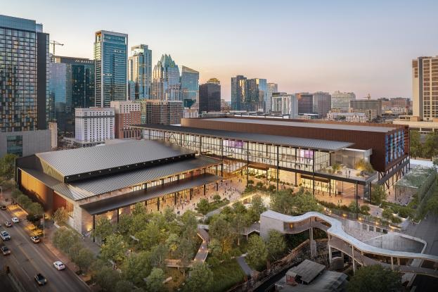 A modern convention center bustling with activity, highlighting major convention center openings and expansions.